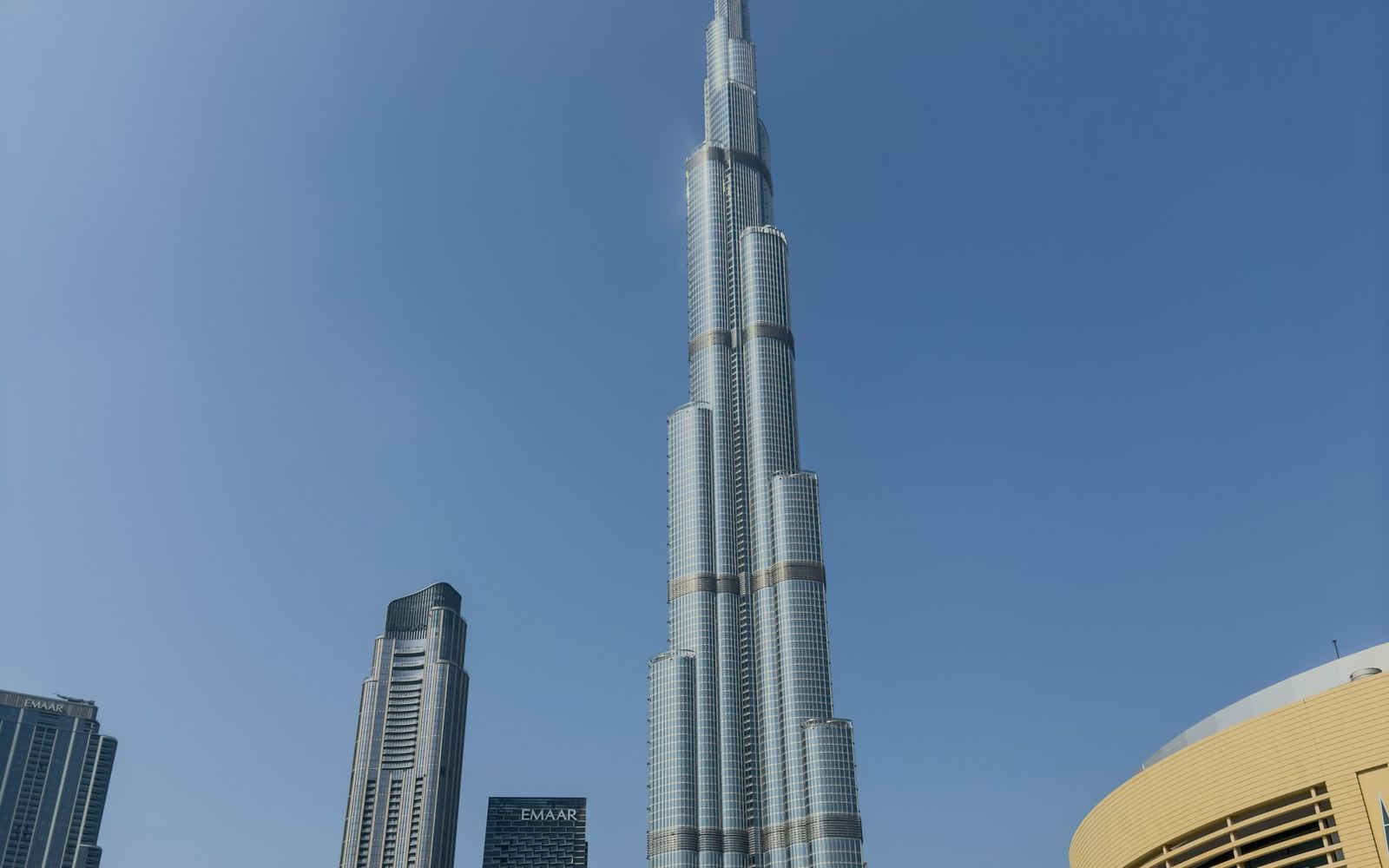 The Burj Khalifa rising above Downtown Dubai in flat daylight