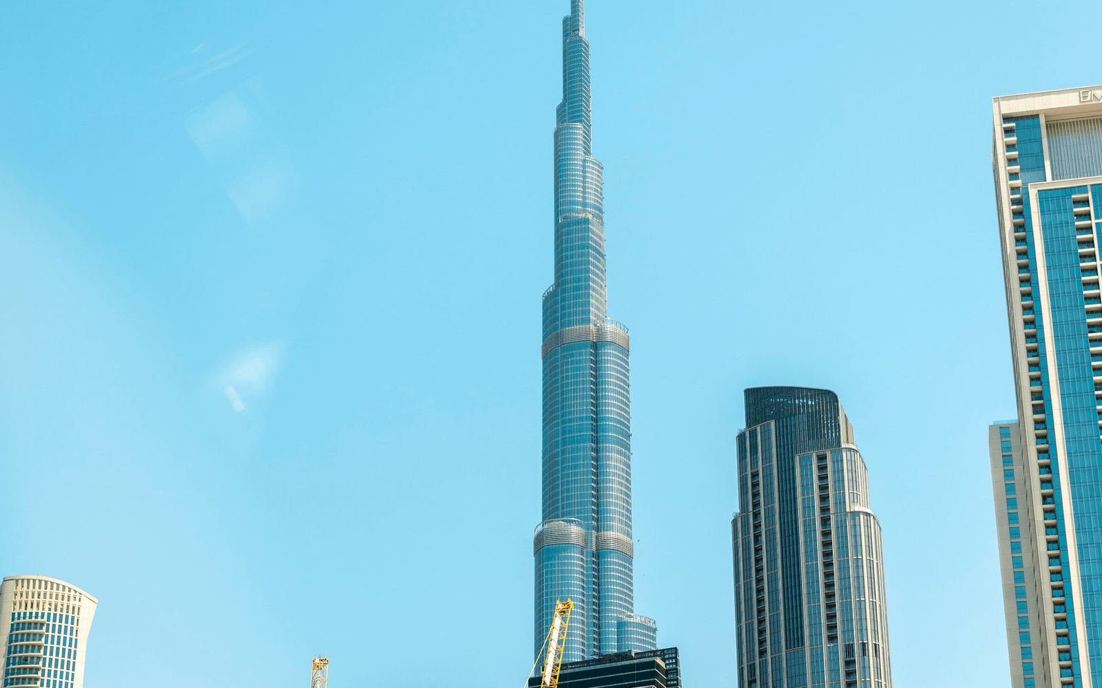 Dubai towers seen from street level, looking straight up the facades